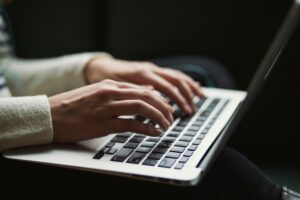 A person typing on a laptop